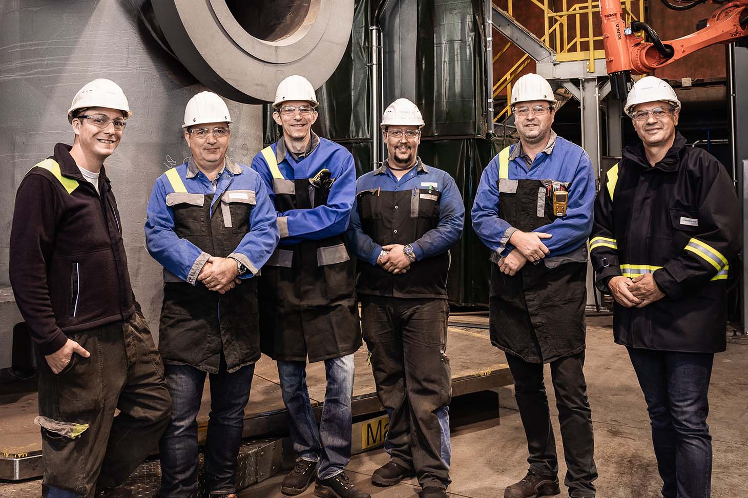 Group photo of the robot welding system project team in the plant