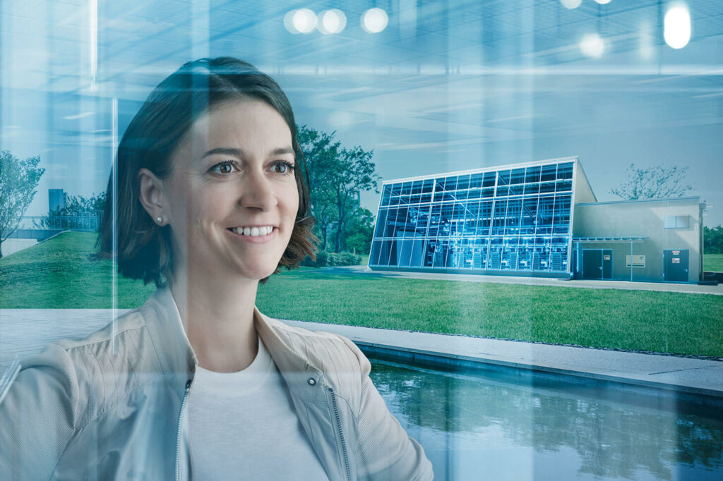 imagephoto voestalpine, an employee and the glass facade of the h3future plant in the background