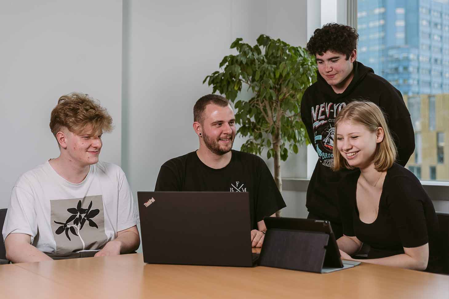 Julian bei der Ausbildung von drei Lehrlingen an einem Tisch