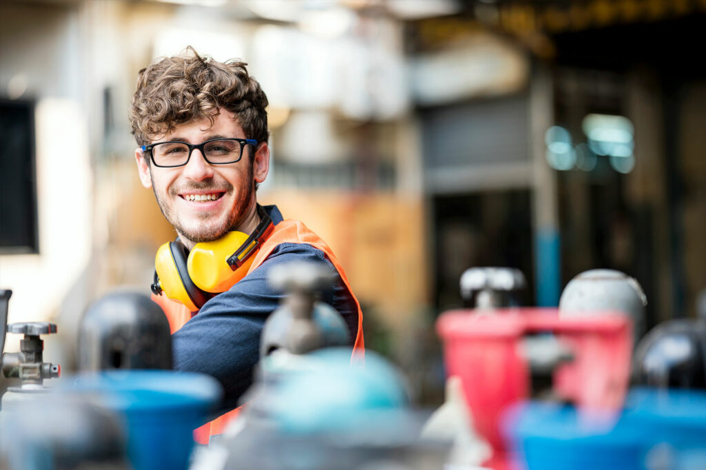 Voestalpine employee in the laboratory, hydrogen cylinders in front of him