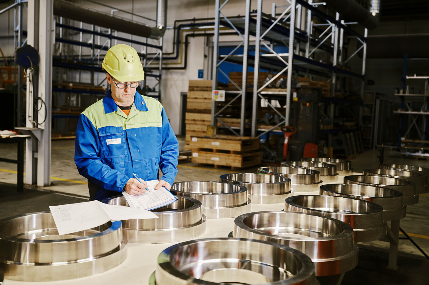 voestalpine employees for lightweight construction in aviation inspecting stainless steel parts