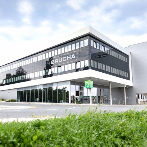 BRUCHA company building exterior view, modern building with concrete columns and glass façade