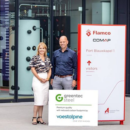 Flamco Building technology. information board for visitors, next to two employees