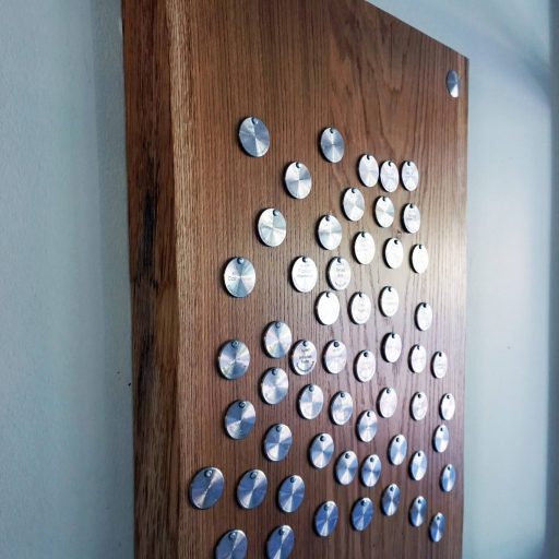 After completing their training, young skilled workers nail a plaque with their name and occupation into the apprenticeship tree