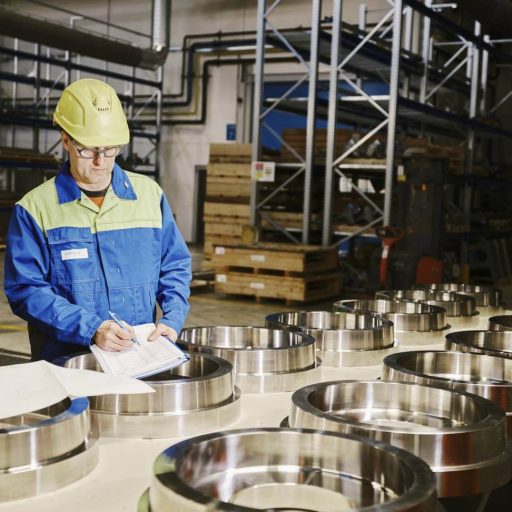 An employee checks engine disks