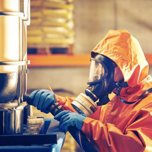 a worker wears a full-body protective suit and a respirator face mask with filter