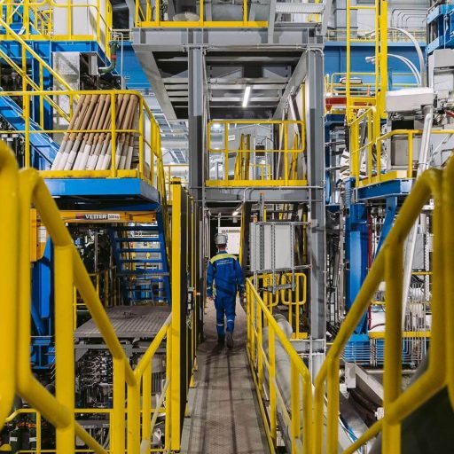 Employee walks through a narrow corridor in the new stainless steel plant